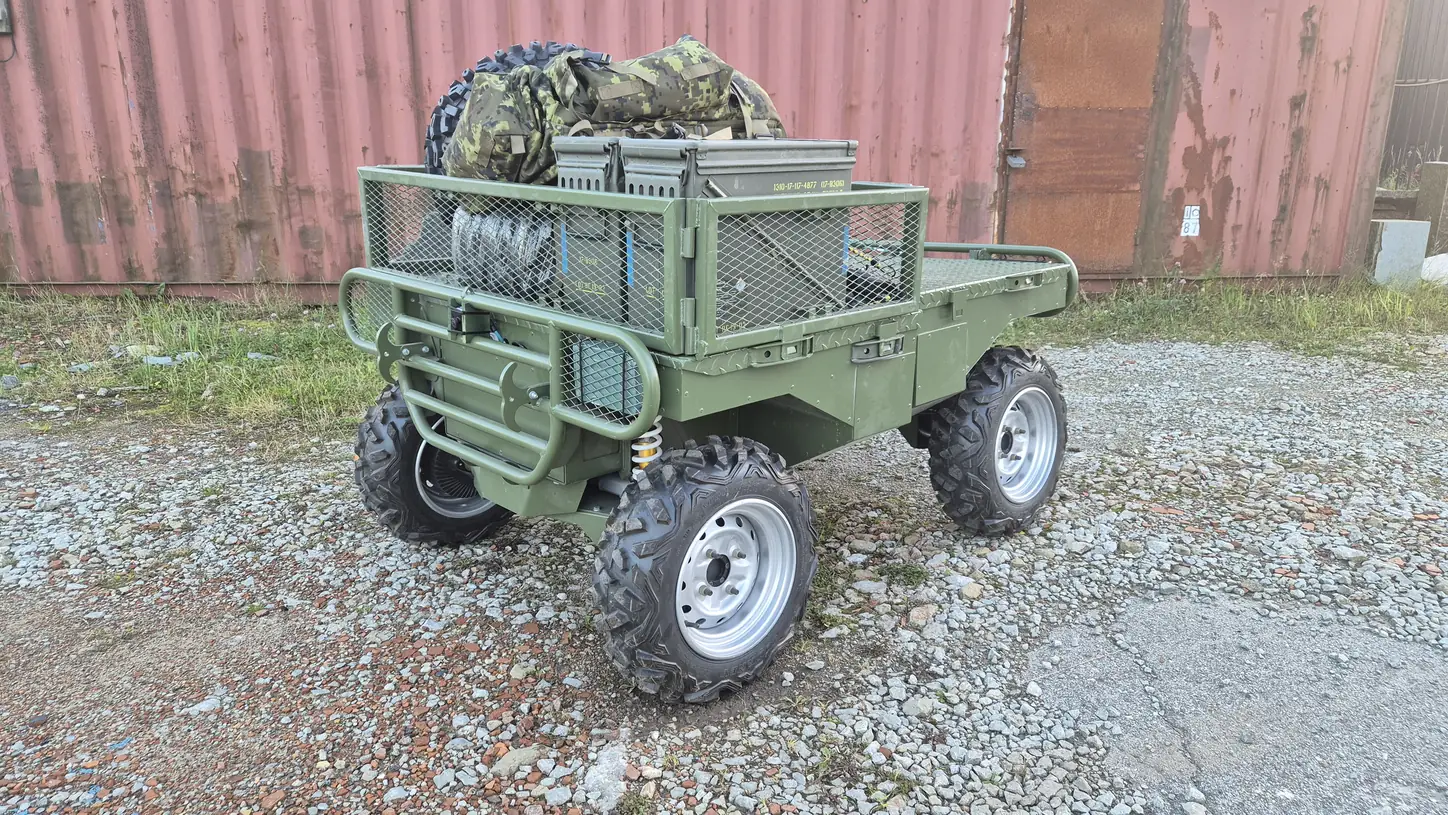 Badger loaded with ammunition boxes, a winch, a spare wheel and a camouflage pack.